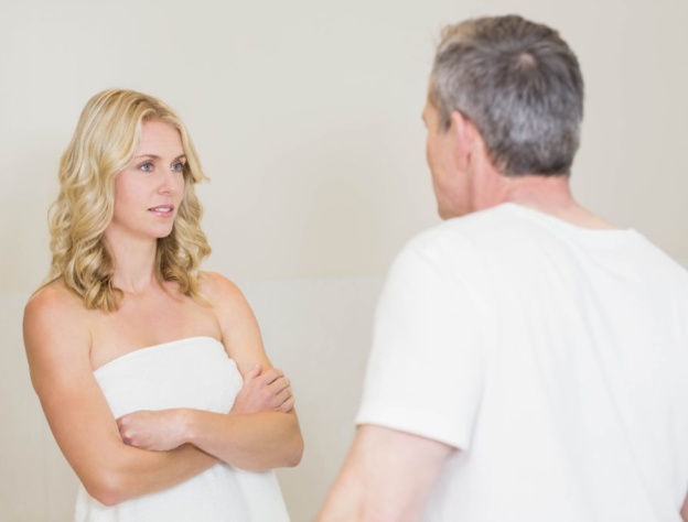 Staged image of a couple arguing, the woman crossing her arms and looking unimpressed at whatever the man is saying